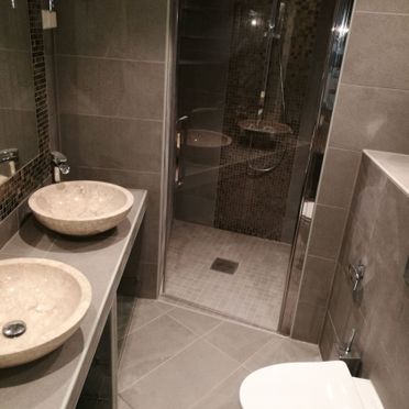 Renovert bad med dobbel vaskeservant og stor flislagt dusj